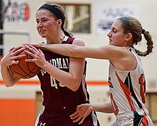 HOWLAND, OHIO - DECEMBER 23, 2016: Annalisa Cordova #43 of Boardman attempts to rip the ball away from Gabby Hartzell #10 of Howland during the second half of their game Friday night at Howland High School. DAVID DERMER | THE VINDICATOR