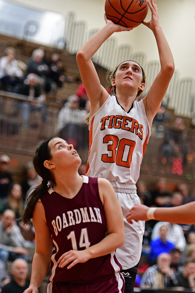 HOWLAND, OHIO - DECEMBER 23, 2016: Alex Ochman #30 of Howland puts up a shot over Lauren Pavlansky #14 of Boardman during the second half of their game Friday night at Howland High School. DAVID DERMER | THE VINDICATOR