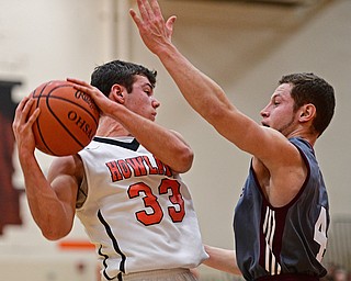 HOWLAND, OHIO - DECEMBER 23, 2016: Kevin Moamis #33 of Howland secures a rebound while being pressured by Mike Melewski #4 of Boardman during the first half of their game Friday night at Howland High School. DAVID DERMER | THE VINDICATOR