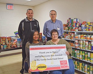 SPECIAL TO THE VINDICATOR
Easter Seals of Mahoning, Trumbull and Columbiana counties recently partnered with Midas of Austintown and Boardman to collect holiday baskets. Midas offered free oil changes to those who donated four non-perishable items. Easter Seals received enough donations to fulfill all requests for family meals throughout the holidays. In front, from left, are Danielle Adair, special event coordinator, and Theresa Ross, billing coordinator. In back are, Anthony Costanzo, Midas manager, and Tim Nelson, CEO of Easter Seals. Easter Seals provides physical, aquatic, occupational and speech therapies, an adult day care center, audiology, a child development center, a community center for the deaf, home delivered meals, a skill development center, transportation and weekend respite for medically fragile children. For information go to www.mtc.easterseals.com or call 330-743-1168. Midas can be reached at 330-793-9033.

SPECIAL TO THE VINDICATOR