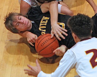 Crestviews Scott Murry (30) fights for a loose ball with Brandon Youngs (21) and Jaxon Anderson of South Range during the first half of Friday nights matchup at South Range High School.  Dustin Livesay  |  The Vindicator  12/23/16  South Range High School.