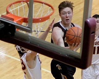 Crestview's Dalton Palmer (20) puts in a layup while being defended by South Range's Hunter Solvesky (22) during the first half of Friday nights matchup at South Range High School.  Dustin Livesay  |  The Vindicator  12/23/16  South Range High School.