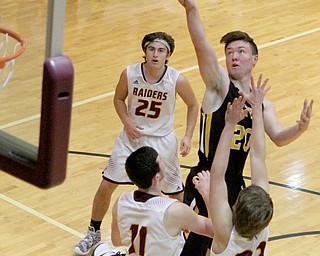 Crestview's Dalton Palmer (20) puts up a shot while beinf defended by Soth Range's Raniel Ritter (11) and Hunter Solvesky (22) during the first half of Friday nights matchup at South Range High School.  Dustin Livesay  |  The Vindicator  12/23/16  South Range High School.