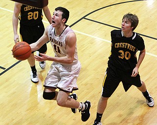 Daniel Ritter (11) of South Range goes in for a layup after getting past the defense of Crestviews Scott Murry (30) during the second half of Friday nights matchup at South Range High School.  Dustin Livesay  |  The Vindicator  12/23/16  South Range High School.