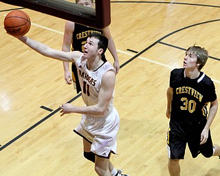 Daniel Ritter (11) of South Range goes in for a layup after getting past the defense of Crestviews Scott Murry (30) during the second half of Friday nights matchup at South Range High School.  Dustin Livesay  |  The Vindicator  12/23/16  South Range High School.