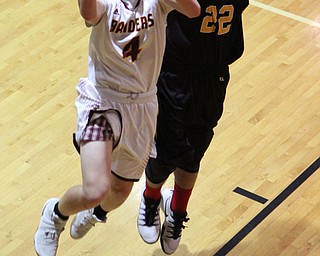 Brennan Toy (4) of South Range goes up for a layup while being defended by Crestview's Hunter Woodrong (22) during the second half of Friday nights matchup at South Range High School.  Dustin Livesay  |  The Vindicator  12/23/16  South Range High School.