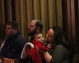 Amber Crawford of Poland holds her daughter Ella Mae(3 mo.) as children participate in Ring-A-Lings at Boardman United Methodist Church in Boardman on Saturday, Dec. 24, 2016...(Nikos Frazier | The Vindicator)..