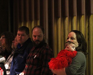 Amber Crawford of Poland holds her daughter Ella Mae(3 mo.) as children participate in Ring-A-Lings at Boardman United Methodist Church in Boardman on Saturday, Dec. 24, 2016...(Nikos Frazier | The Vindicator)..