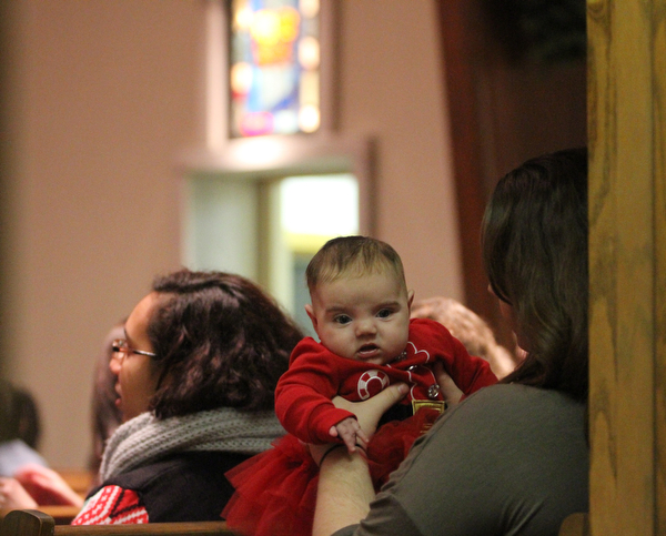Amber Crawford of Poland holds her daughter Ella Mae(3 mo.) as children participate in Ring-A-Lings at Boardman United Methodist Church in Boardman on Saturday, Dec. 24, 2016...(Nikos Frazier | The Vindicator)..
