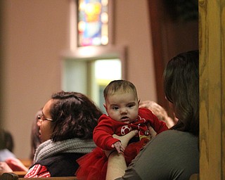 Amber Crawford of Poland holds her daughter Ella Mae(3 mo.) as children participate in Ring-A-Lings at Boardman United Methodist Church in Boardman on Saturday, Dec. 24, 2016...(Nikos Frazier | The Vindicator)..