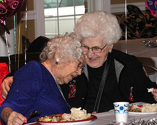 Sophie Antolik(left) rests her shoulder on her friend Mim Laouere, 94 of Youngston as Sophie celebrates her 100th birthday at the Bradford Green Clubhouse at Westford Condos in Canfield on Saturday, Dec. 24, 2016...(Nikos Frazier | The Vindicator)..
