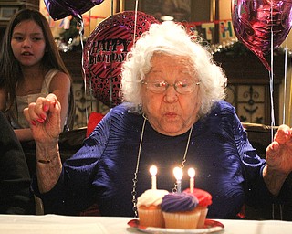 Sophie Antolik blows out the candles as she celebrates her 100th birthday at the Bradford Green Clubhouse at Westford Condos in Canfield on Saturday, Dec. 24, 2016...(Nikos Frazier | The Vindicator)..