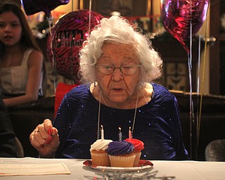 Sophie Antolik blows out the candles as she celebrates her 100th birthday at the Bradford Green Clubhouse at Westford Condos in Canfield on Saturday, Dec. 24, 2016...(Nikos Frazier | The Vindicator)..