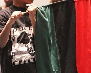 William D. Lewis the Vindicator Jermaine hodge, 8, of Youngstown holds an African flag  during 12-26-16 Kwanza event at New Bethel Baptist Church in Youngstown