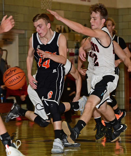 VIENNA, OHIO - DECEMBER 26, 2016: Robby Ambrose #14 of Mineral Ridge dribbles away from Jordan Brown #12 of Mathews during the first half of their game Monday night at Mathews High School. DAVID DERMER | THE VINDICATOR