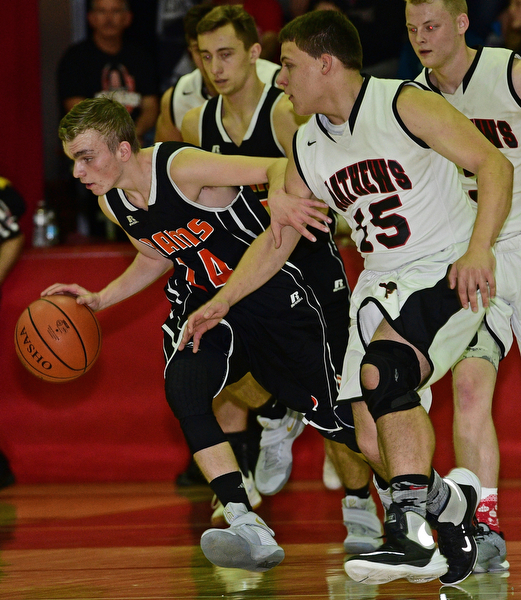 VIENNA, OHIO - DECEMBER 26, 2016: Robby Ambrose #14 of Mineral Ridge dribbles up court while being pressured by Koby Zupko #15 of Mathews during the first half of their game Monday night at Mathews High School. DAVID DERMER | THE VINDICATOR