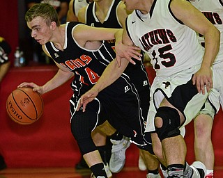 VIENNA, OHIO - DECEMBER 26, 2016: Robby Ambrose #14 of Mineral Ridge dribbles up court while being pressured by Koby Zupko #15 of Mathews during the first half of their game Monday night at Mathews High School. DAVID DERMER | THE VINDICATOR