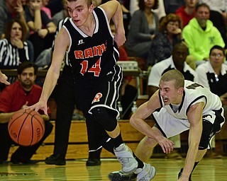 VIENNA, OHIO - DECEMBER 26, 2016: Robby Ambrose #14 of Mineral Ridge dribbles away from a diving Kenny Wallace #11 of Mathews during the first half of their game Monday night at Mathews High School. DAVID DERMER | THE VINDICATOR