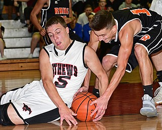 VIENNA, OHIO - DECEMBER 26, 2016: Koby Zupko #15 of Mathews and Justin Cox #11 of Mineral Ridge wrestle for the loose ball during the first half of their game Monday night at Mathews High School. DAVID DERMER | THE VINDICATOR