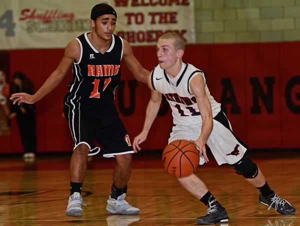VIENNA, OHIO - DECEMBER 26, 2016: Kenny Wallace #11 of Mathews drives on Jarred Miller #10 of Mineral Ridge during the first half of their game Monday night at Mathews High School. DAVID DERMER | THE VINDICATOR
