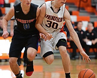 NEW Middletown, OHIO - DECEMBER 28, 2016: Jake Ford #30 of Springfield drives on Nicholas Frank #0 of Lordstown during the first half of their game Wednesday night at Springfield High School. DAVID DERMER | THE VINDICATOR