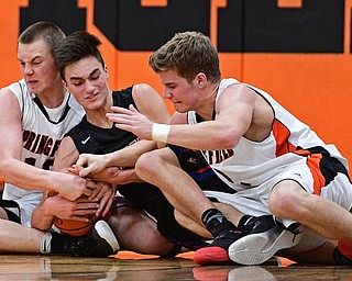 NEW Middletown, OHIO - DECEMBER 28, 2016: Nicholas Frank #0 of Lordstown attempts to hold on to the ball while John Ritter #13 and Frankie Centofanti #2 of Springfield during the first half of their game Wednesday night at Springfield High School. DAVID DERMER | THE VINDICATOR