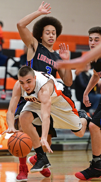 NEW Middletown, OHIO - DECEMBER 28, 2016: Jake Ford #30 of Springfield trips while being guarded by Michon Peterson #3 of Lordstown during the first half of their game Wednesday night at Springfield High School. DAVID DERMER | THE VINDICATOR