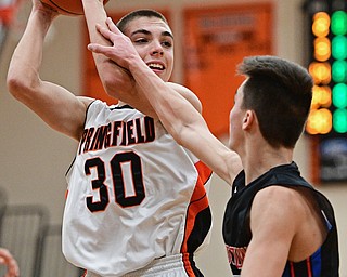 NEW Middletown, OHIO - DECEMBER 28, 2016: Jake Ford #30 of Springfield looks to pass the ball while being pressured by Nicholas Frank #0 of Lordstown during the first half of their game Wednesday night at Springfield High School. DAVID DERMER | THE VINDICATOR
