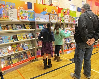 Neighbors | Alexis Bartolomucci.Students look at the different books available for sale during the Scholastic Book Fair on Nov. 15 at Austintown Intermediate School.