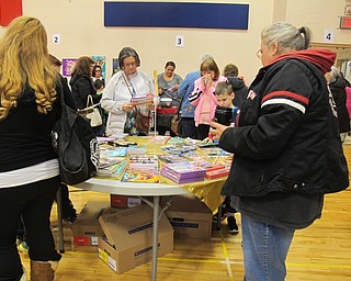 Neighbors | Alexis Bartolomucci.Students and their family members at Austintown Intermediate School looked at the tables full of books during the Scholastic Book Fair on Nov. 15.