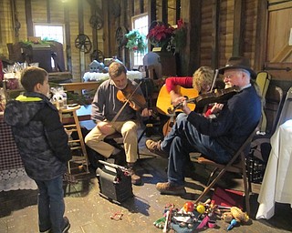 Neighbors | Alexis Bartolomucci.One of the children at Lanterman's Mill Olde Fashioned Christmas on Nov. 26 enjoyed the live music from the band One String Short.