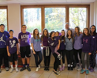 Neighbors | Abby Slanker.Canfield Village Middle School eighth-grade students, along with assistant principal Michael Flood (back) and event coordinator Nicole Billak (far right) showed their support of World Pancreatic Cancer Awareness Day by wearing purple on Nov. 17.