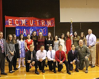 Neighbors | Abby Slanker.Under the direction of social studies teachers Mike Kerensky (back right) and Jason Jugenheimer (back left) eighth-grade student volunteers prepared and executed the Canfield Village Middle School’s Veterans Day program, which featured Lieutenant Colonel James Torok of the United States Air Force (front right) on Nov. 11.