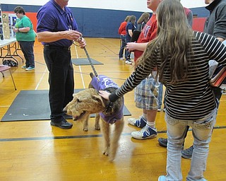 Neighbors | Alexis Bartolomucci.Students gathered around therapy dog, Louie, from K-9's for Compassion, at Austintown Fitch High School on Dec. 2.