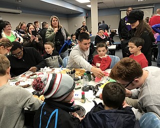 Neighbors | Alexis Bartolomucci.Students from the Sigma Alpha Epsilon fraternity helped children decorate cookies during the tree lighting event at Akron's Children Hospital in Boardman on Dec. 1.