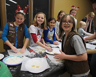 Neighbors | Alexis Bartolomucci.Girl Scouts from Troop 88090 rolled and cut out their cookie dough into shapes to bake during the Cookies with Santa event on Dec. 21 at Boardman Park.