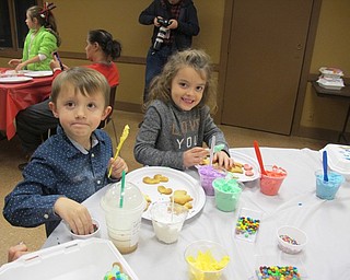 Neighbors | Alexis Bartolomucci.Jason and Maddi decorate their freshly baked cookies with frosting, sprinkles and candy during the Cookies with Sanda event on Dec. 21 at Boardman Park.