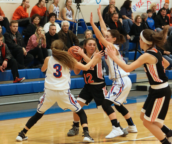 Springfield's Haley LaMarticella (12) looks to pass while being double teamed by Maddy Owen (3) and Erica DeZee (13) of Western Reserve during the second quarter of Thursday nights matchup at Western Reserve High School in Berlin Center.  Dustin Livesay  |  The Vindicator  12/29/16 Wester Reserve High School.
