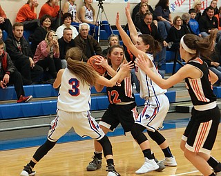 Springfield's Haley LaMarticella (12) looks to pass while being double teamed by Maddy Owen (3) and Erica DeZee (13) of Western Reserve during the second quarter of Thursday nights matchup at Western Reserve High School in Berlin Center.  Dustin Livesay  |  The Vindicator  12/29/16 Wester Reserve High School.