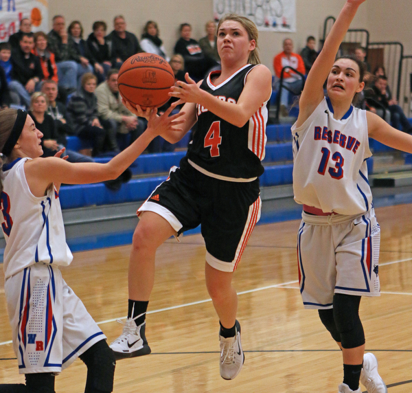 Makenzy Capouellez (4) of Springfield goes up for a layup while being defended by Western Reserve's Maddy Owen (3) and Erica DeZee (13) during the second quarter of Thursday nights matchup at Western Reserve High School in Berlin Center.  Dustin Livesay  |  The Vindicator  12/29/16 Wester Reserve High School.
