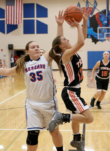 Haley LaMortizella (12) of Springfield puts up a shot while being defended by Western Reserve's Layla Woolf (35) during the third quarter of Thursday nights matchup at Western Reserve High School in Berlin Center.  Dustin Livesay  |  The Vindicator  12/29/16 Wester Reserve High School.