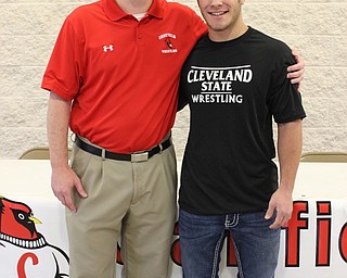 Neighbors | Abby Slanker.Canfield High School senior wrestler Georgio Poullas and Canfield High School wrestling coach Dean Conley were all smiles at Poullas’ letter of intent signing ceremony during which he formally committed to Cleveland State University and signed his NCAA national letter of intent Dec. 2.