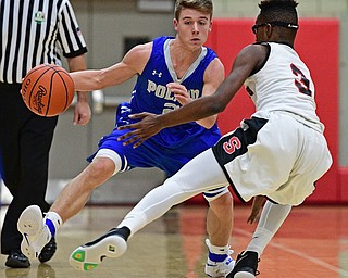 STRUTHERS, OHIO - DECEMBER 30, 2016: Mike Diaz #2 of Poland dribbles up court while being cut off by Kevin Traylor #3 of Struthers during the first half of their game Friday night at Struthers High School. DAVID DERMER | THE VINDICATOR