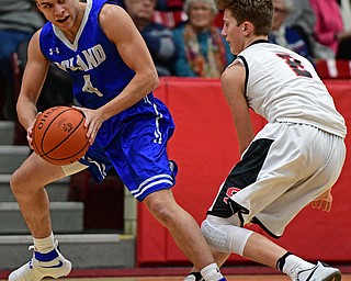 STRUTHERS, OHIO - DECEMBER 30, 2016: Trent Lutz #4 of Poland trips over Carson Ryan #2 of Struthers while securing the basketball during the first half of their game Friday night at Struthers High School. DAVID DERMER | THE VINDICATOR