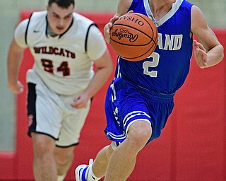 STRUTHERS, OHIO - DECEMBER 30, 2016: Mike Diaz #2 of Poland dribbles away from Jaret Jacubec #24 of Struthers after a turnover during the first half of their game Friday night at Struthers High School. DAVID DERMER | THE VINDICATOR