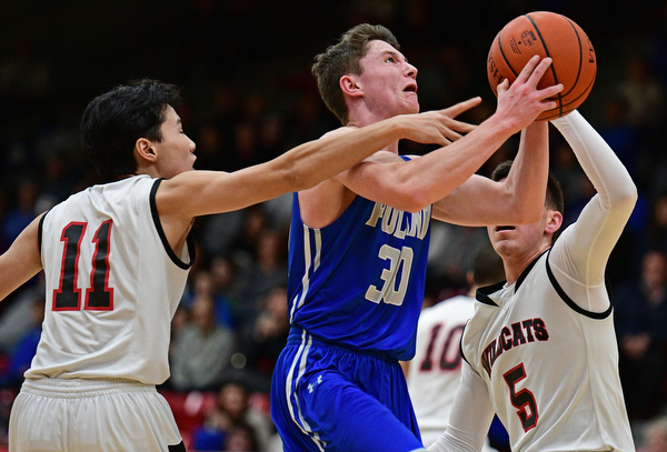 STRUTHERS, OHIO - DECEMBER 30, 2016: Kyle Patterson #30 of Poland goes tot he basket while being pressured by Ethan Vo #11 and Andrew Carbon #5 of Struthers during the first half of their game Friday night at Struthers High School. DAVID DERMER | THE VINDICATOR