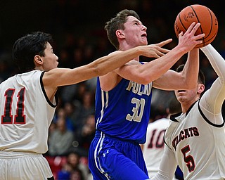 STRUTHERS, OHIO - DECEMBER 30, 2016: Kyle Patterson #30 of Poland goes tot he basket while being pressured by Ethan Vo #11 and Andrew Carbon #5 of Struthers during the first half of their game Friday night at Struthers High School. DAVID DERMER | THE VINDICATOR