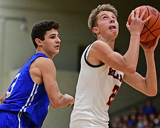 STRUTHERS, OHIO - DECEMBER 30, 2016: Carson Ryan #2 of Struthers goes to the basket after getting around Braeden O'Shaungnessy #3 of Poland during the second half of their game Friday night at Struthers High School. DAVID DERMER | THE VINDICATOR