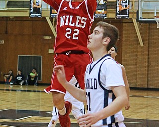 Corbin Foy (22) of Niles puts up a jump shot over Joe Ragozzin (21) during the second quarter of Friday nights matchup at McDonald High School.  Dustin Livesay  |  The Vindicator  12/30/16  McDonald.