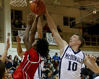 Evan Magill (10) of McDonal blocks a shot taken by Daljon Motley (2) of Niles during the second quarter of Friday nights matchup at McDonald High School.  Dustin Livesay  |  The Vindicator  12/30/16  McDonald.